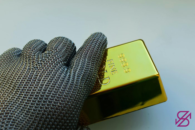 تصویر دستی که دستکش دارد و یک شنمش طلا را در اختیار گرفته است 